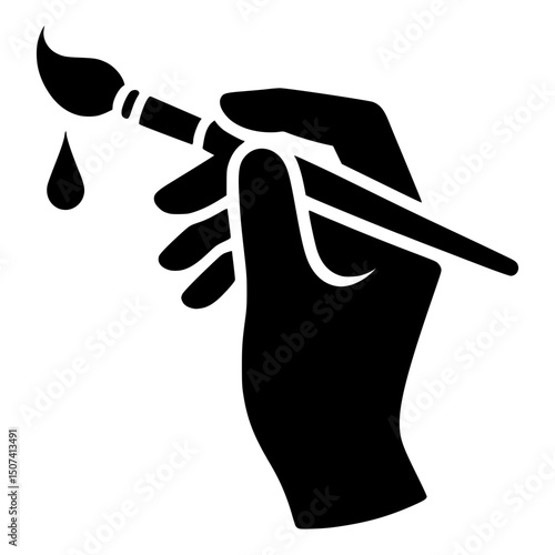 A hand holding a paintbrush, a creative symbol of art and painting