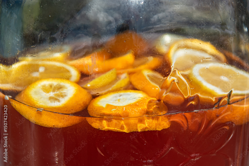 Close-up of sliced lemon in glass jar with lemonade