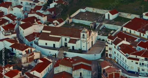 Aerial view of small village with windmill and picturesque rooftops, Odeceixe, Portugal