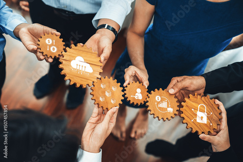 A group of professionals holding wooden gears, symbolizing collaboration in finance, technology, and security. The image represents teamwork and innovative strategies. Amity