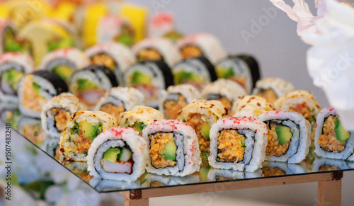 close up view of a plate filled with sliced sushis on a table at a buffet