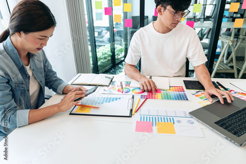Team of creative graphic designer working on color swatch samples chart for selection coloring in inspiration to create new collection at workplace