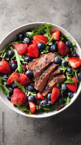 Grilled Steak Salad With Fresh Strawberries and Blueberries in a Bowl
