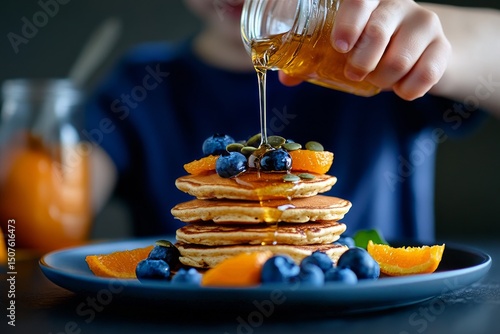 Stack of Pancakes Topped With Blueberries and Honey Drizzled in a Warm Kitche...