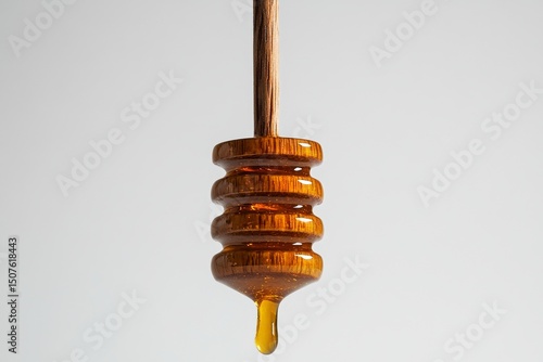 Honey Drips Slowly From a Wooden Dipper Against a Light Background