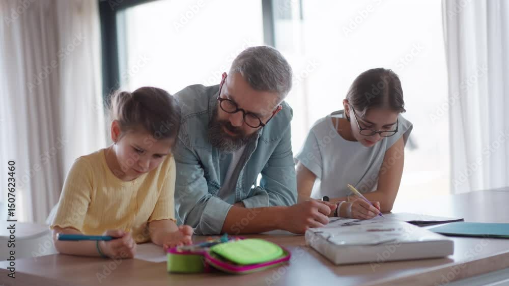 Father helping his daughters with homework. Father helping his daughters with homework.