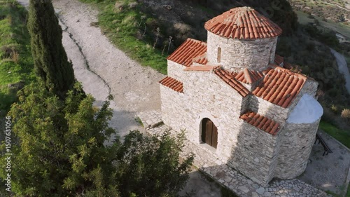 Aerial view of the byzantine Panagia Livadiotissa Chapel near Pano Lefkara, with its red tiled roof and stone walls, nestled on a Cyprus mountainside