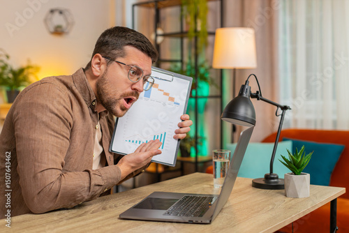 Slika na platnu Upset businessman arguing on laptop call online, displaying report charts and graphs at home office table