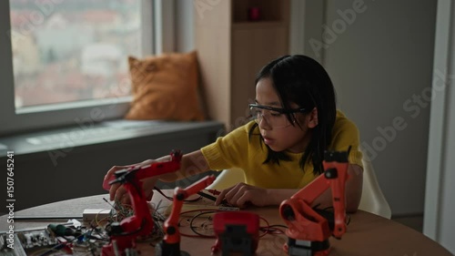Wallpaper Mural Japanese gril building her first homemade robot at home. Torontodigital.ca