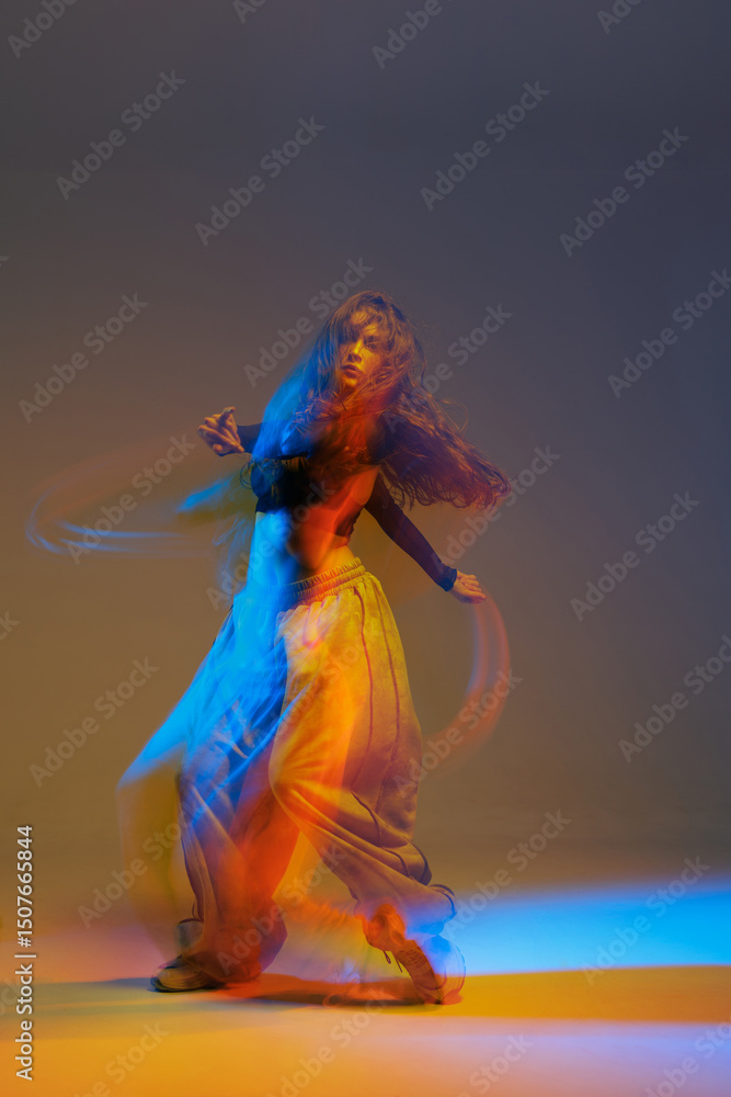 Modern jazz-funk dancer captured mid-motion with expressive blur and neon light trails, highlighting fluidity, color, and movement in an energetic studio performance. Modern jazz-funk dancer captured mid-motion with expressive blur and neon light trails, highlighting fluidity, color, and movement in an energetic studio performance.