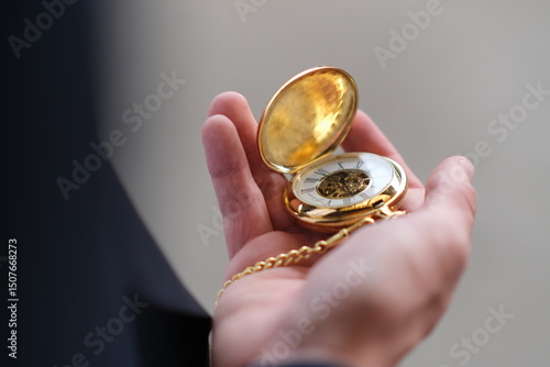 golden watch in hand