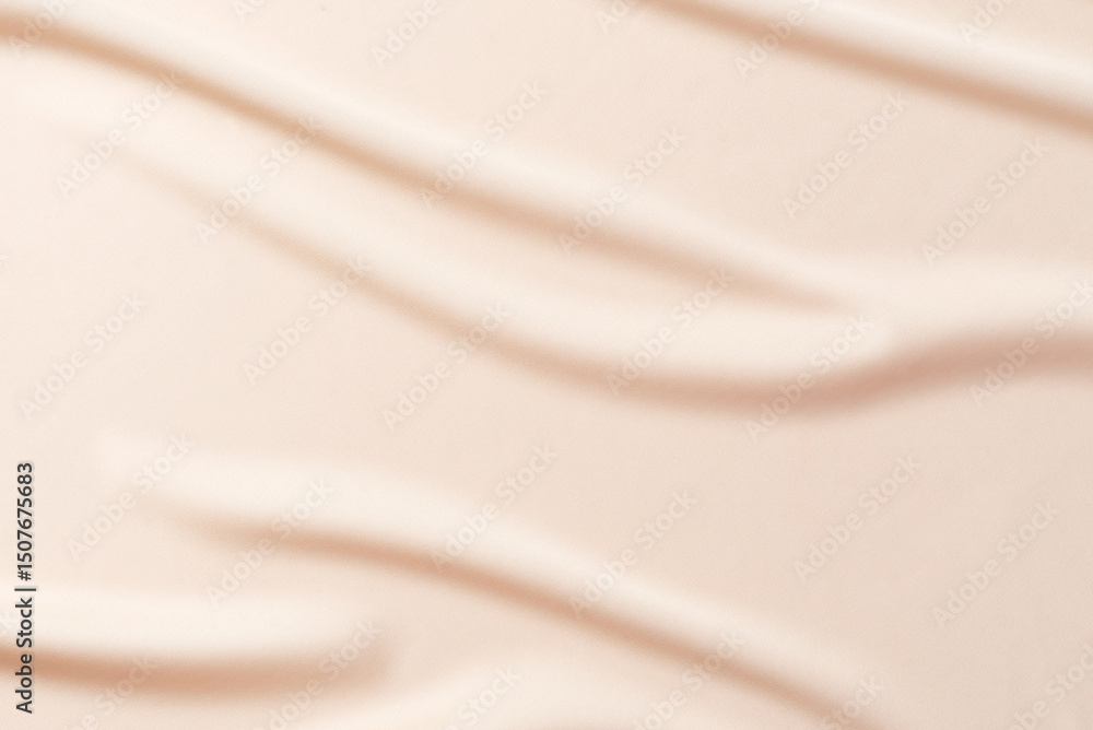 Fototapeta premium Abstract nude background. Soft beige, nude silk satin fabric with soft wavy folds