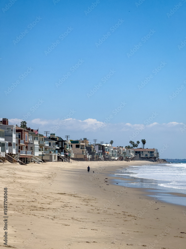Beach house on stilts near water edge at Carbon-La Costa Beach in Malibu, California, USA against blue sky Beach house on stilts near water edge at Carbon-La Costa Beach in Malibu, California, USA against blue sky