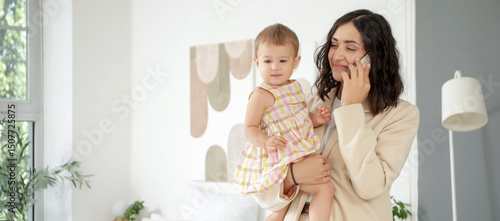 Working mother with her lit...