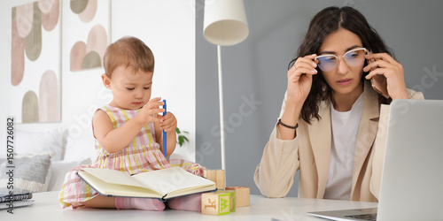 Working mother with her lit...
