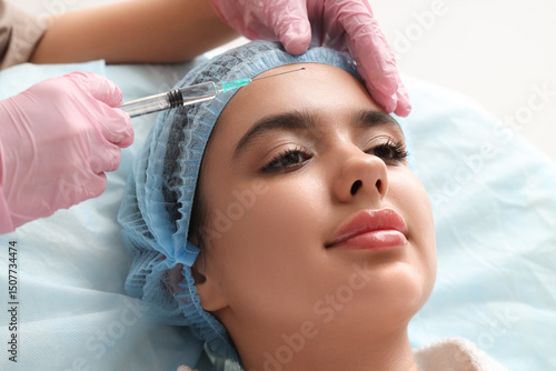Cosmetologist giving inject...