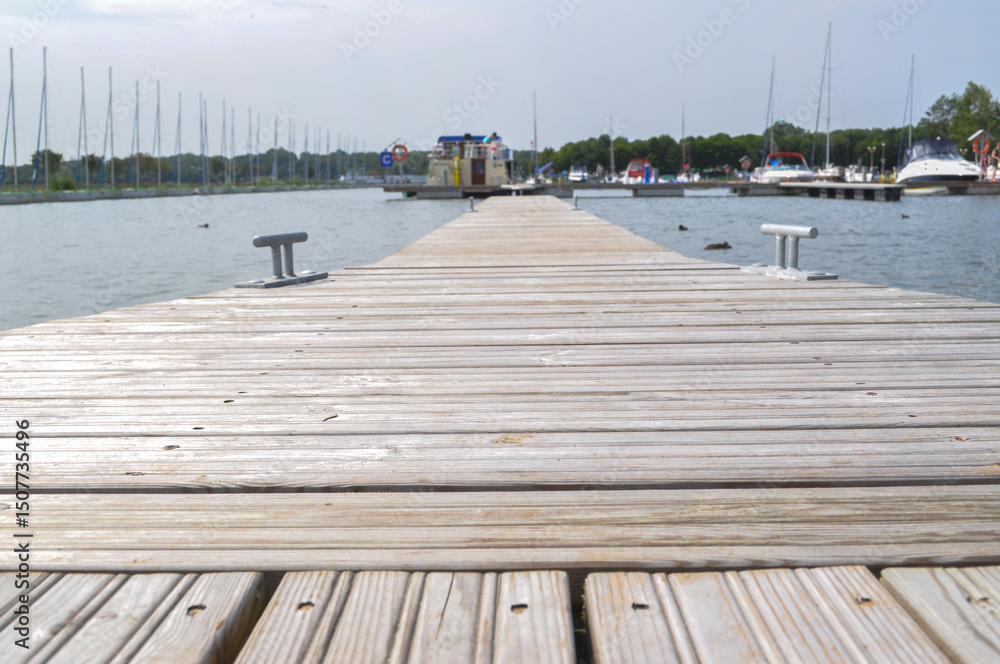 Fototapeta premium wooden bridge on the lake moored boats
