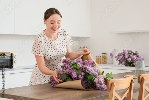 Young woman wrapping lilac ...