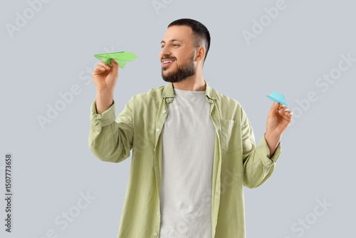 Young man with paper planes...