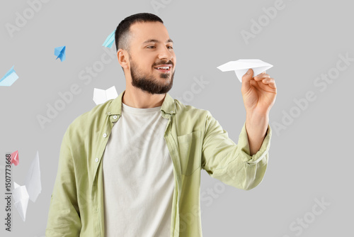 Young man with paper planes...