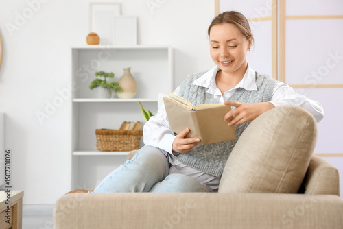 Smiling young woman reading...