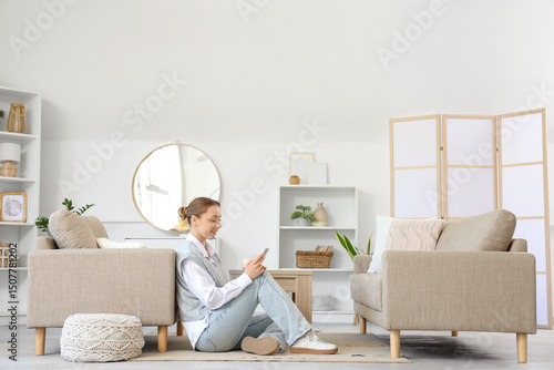 Smiling young woman using m...