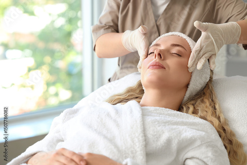 Female beautician massaging...