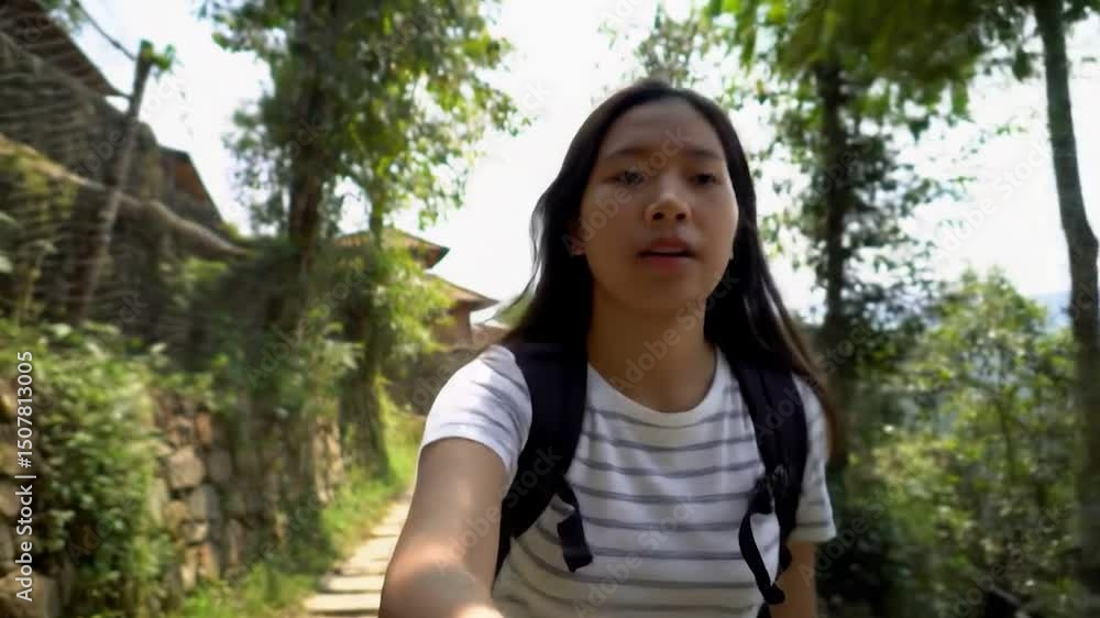 Young Woman Hiking on a Stone Path Through Lush Greenery in Nature Young Woman Hiking on a Stone Path Through Lush Greenery in Nature