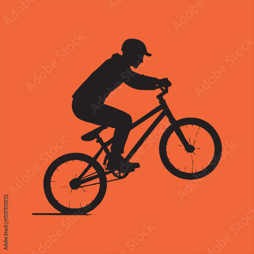 Silhouette of bmx rider performing a wheelie