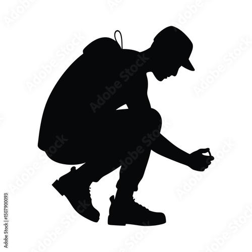 Hiker crouching to tie boot laces silhouette