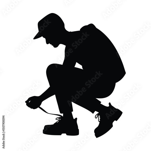 Hiker crouching to tie boot laces silhouette