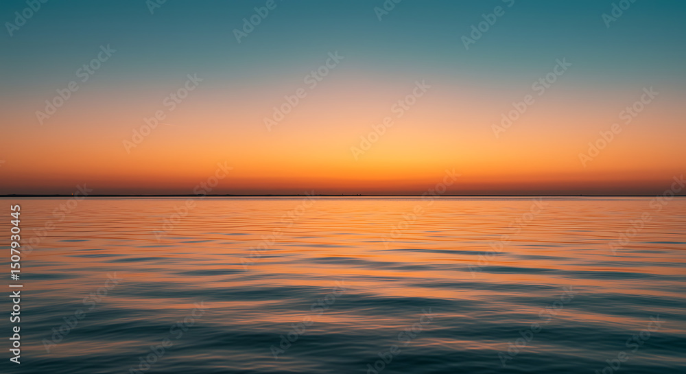 Obraz premium Serene Sunset over Calm Ocean Waters Vibrant Orange and Teal Sky