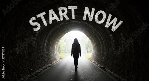 Motivational image of person walking through tunnel toward bright opening with text start now for business and editorial use