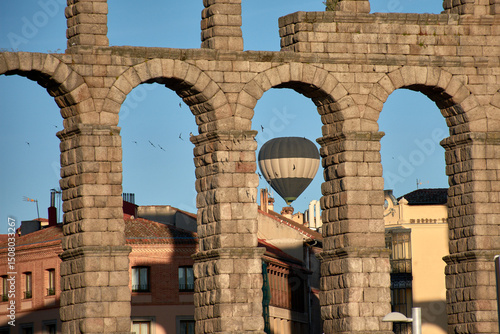 Tourists enjoy a breathtaking Hot air balloon ride above Segovia's rooftops and iconic Aqueduct landmark.