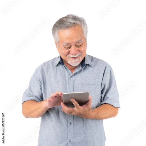 Smiling senior Asian man using digital tablet, wearing casual shirt, looking down and touching screen, enjoying technology, isolated on a transparent background, modern elderly lifestyle concept