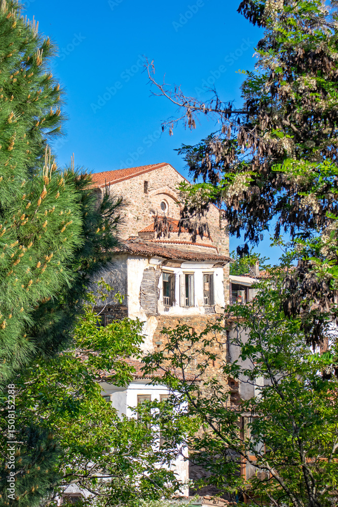 Historical house among natural frames in Sirince village, Izmir. Wooden and stone structure seen through the trees. Authentic architecture idea concept. Historical house among natural frames in Sirince village, Izmir. Wooden and stone structure seen through the trees. Authentic architecture idea concept.