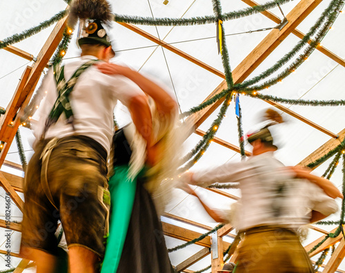 typical bavarian dancers with tradtional clothings at the oktoberfest - blurred