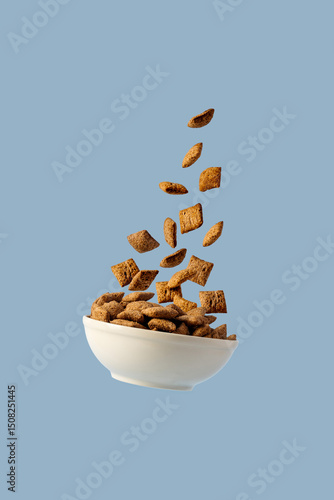 Levitating bowl with chocolate pads cereals nougats, breakfast