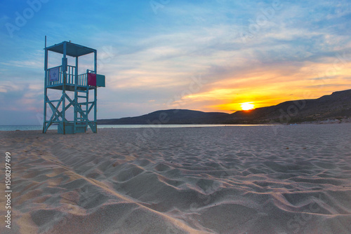 lifeguard station tower at sunset on the beach Simos on the island of Elafoni...