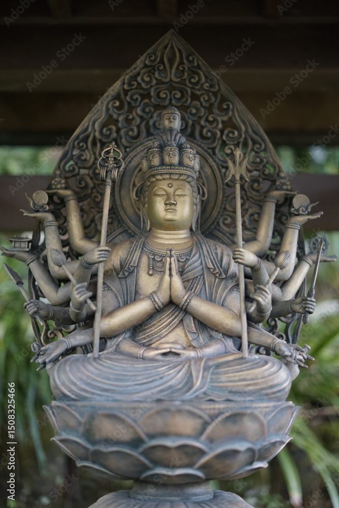 Fototapeta premium Serene Bronze Sculpture Eleven-Headed Kannon Bodhisattva Statue
