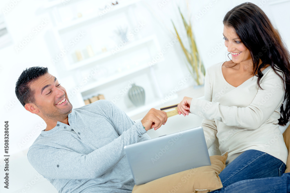 happy young couple buying online using laptop happy young couple buying online using laptop