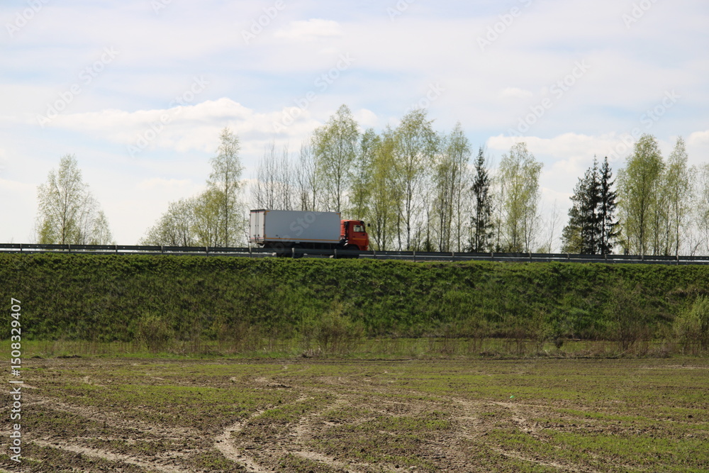 Fototapeta premium A truck is driving on the road,