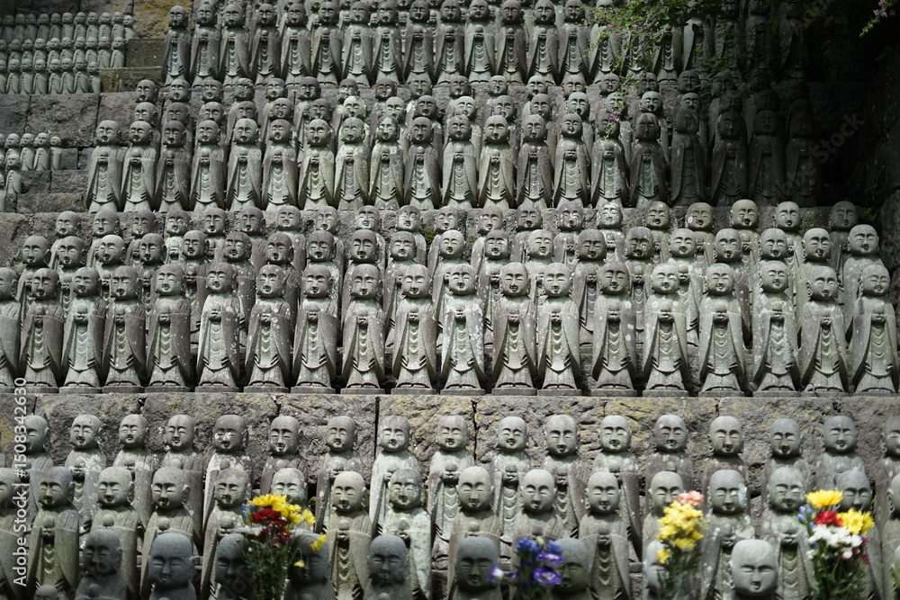 Fototapeta premium Thousands of Jizo Statues A Serene Stone Buddha Hillside in Japan