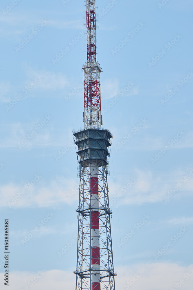 A Telecommunications Tower Stands Tall Against the Clear Blue Sky Above, Punctuating the Landscape A Telecommunications Tower Stands Tall Against the Clear Blue Sky Above, Punctuating the Landscape
