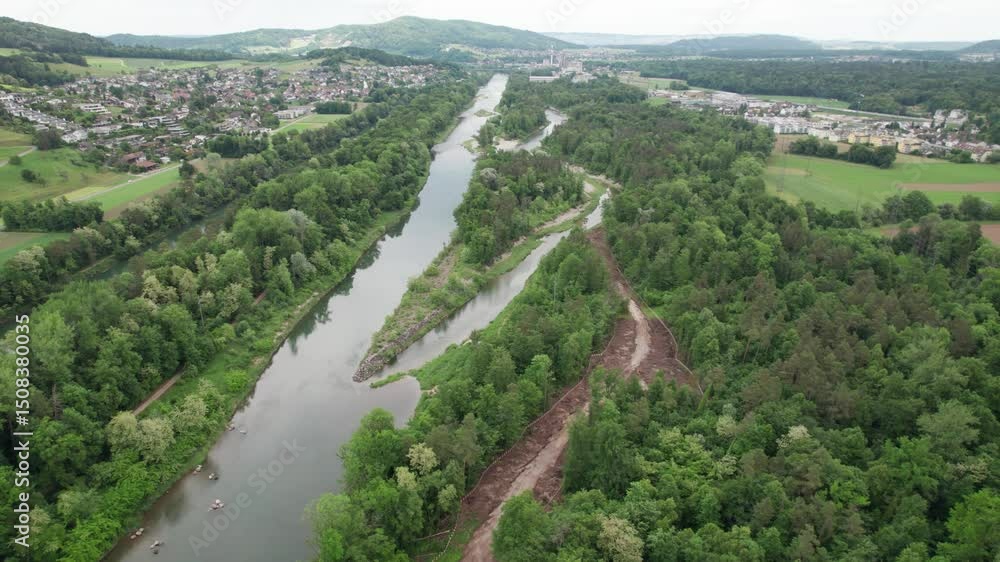 Drone shot of a river restoration project in Aarau, Switzerland. A new river arm is being dug in the forest. Drone shot of a river restoration project in Aarau, Switzerland. A new river arm is being dug in the forest.