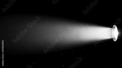 Single bright spotlight beam projecting light with dust particles visible, onto a dark, empty background.