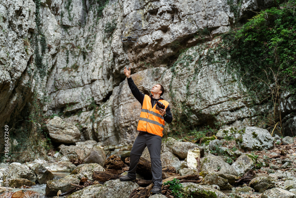 Obraz premium Drone Operator Surveying Rocky Canyon