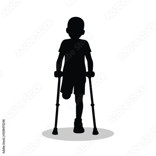 Young boy walking with crutches silhouette.