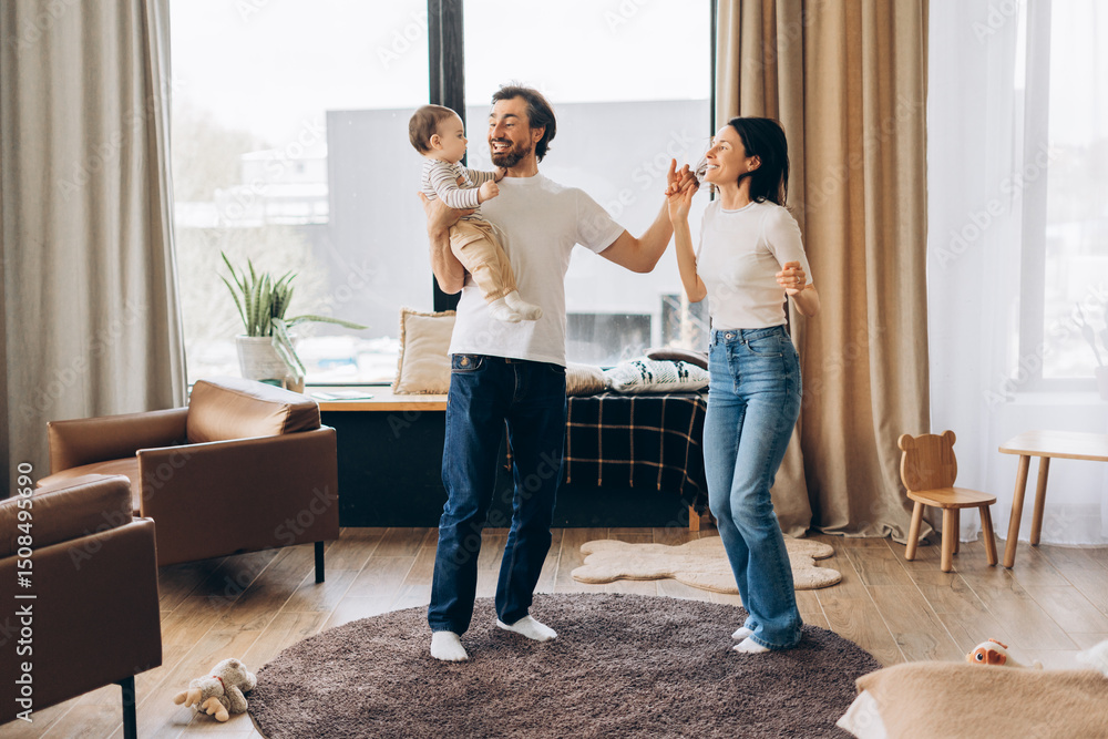 Happy family dancing together in living room, happy parent concept Happy family dancing together in living room, happy parent concept