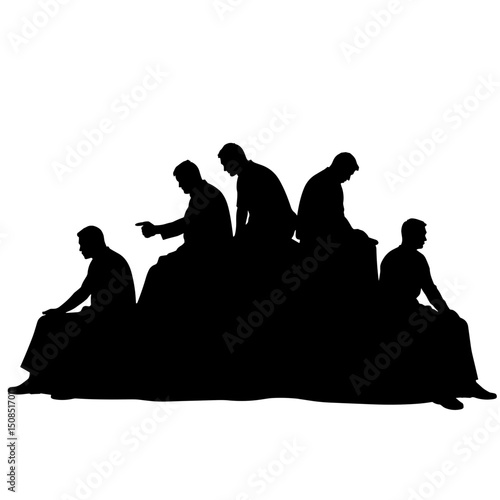 Silhouettes of five men sitting and interacting on a hilltop  